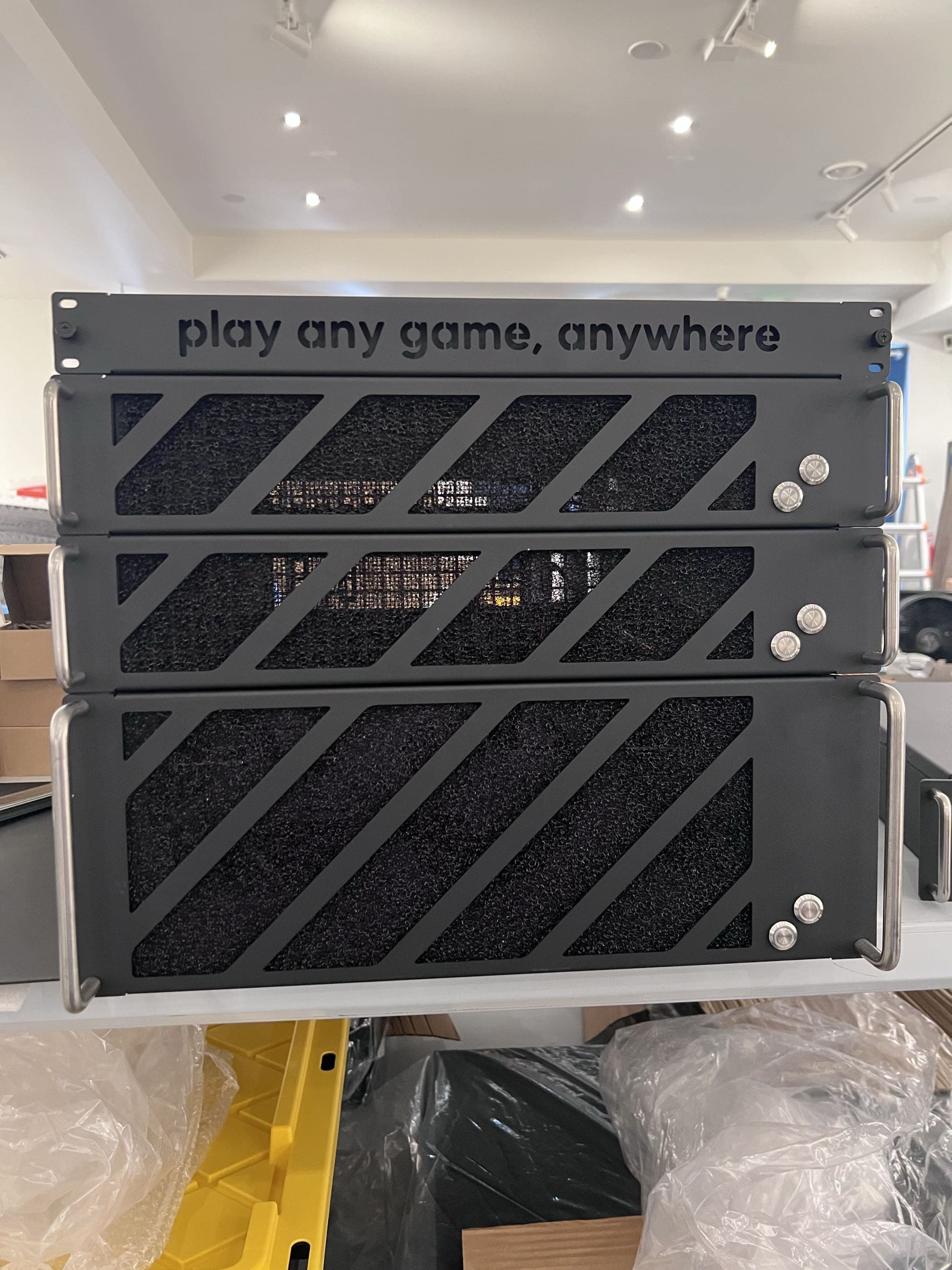 Three production 2U gaming chassis stacked, ready for shipping.