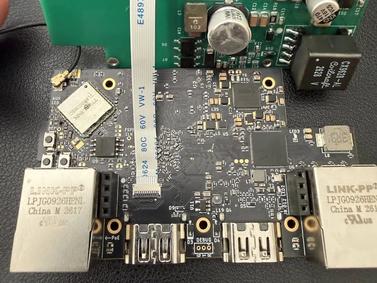 Prototype WarpKVM 01 main board, Wi-Fi side, with the green rev A power board connected above it by a flat flex cable.